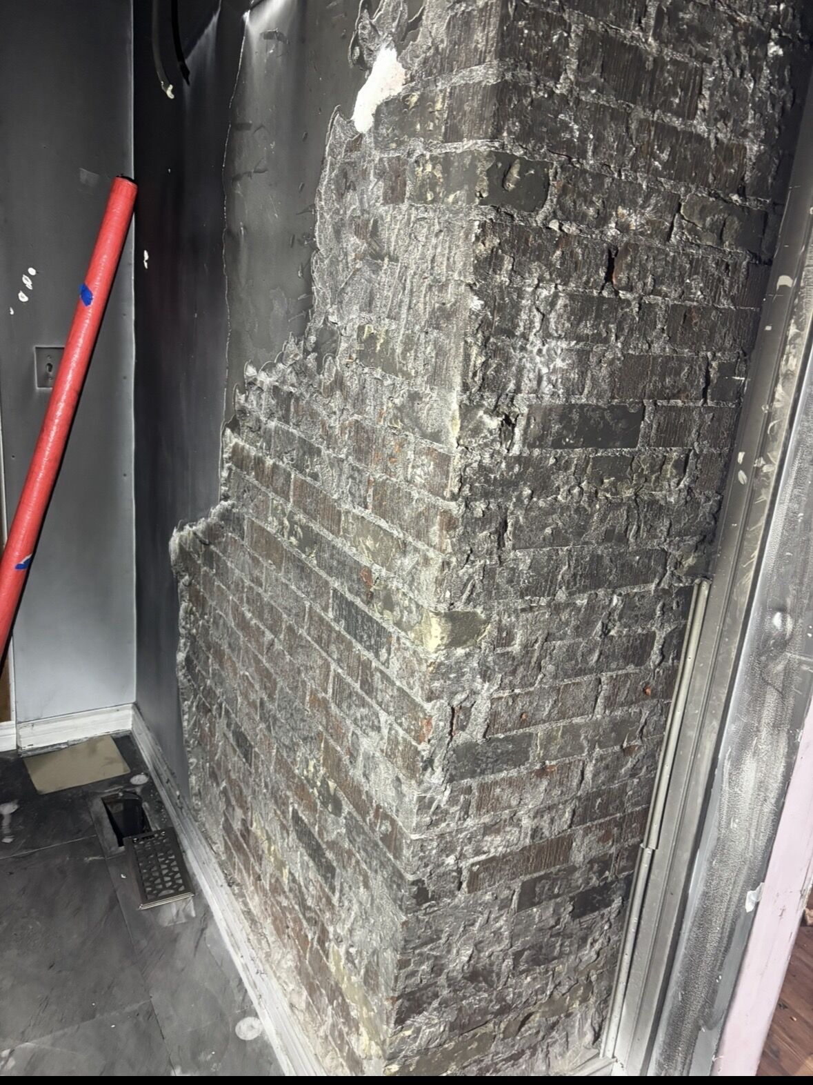 Soot-covered brick chimney from a fire restoration job in Chatham, Ontario — cleaned by Ontario Dry Ice Blasting using dry ice instead of chemicals or water