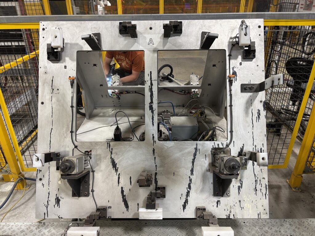 Adhesive and primer buildup on robotic cell fixture before dry ice blasting — Windsor automotive plant
