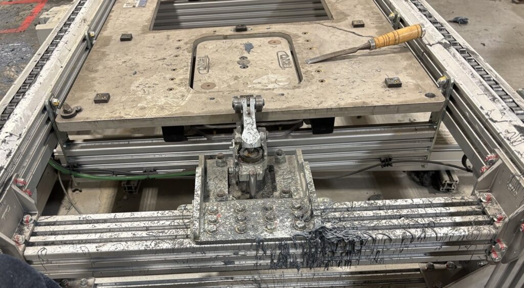 Heavy cured adhesive on aluminum rail before dry ice blasting