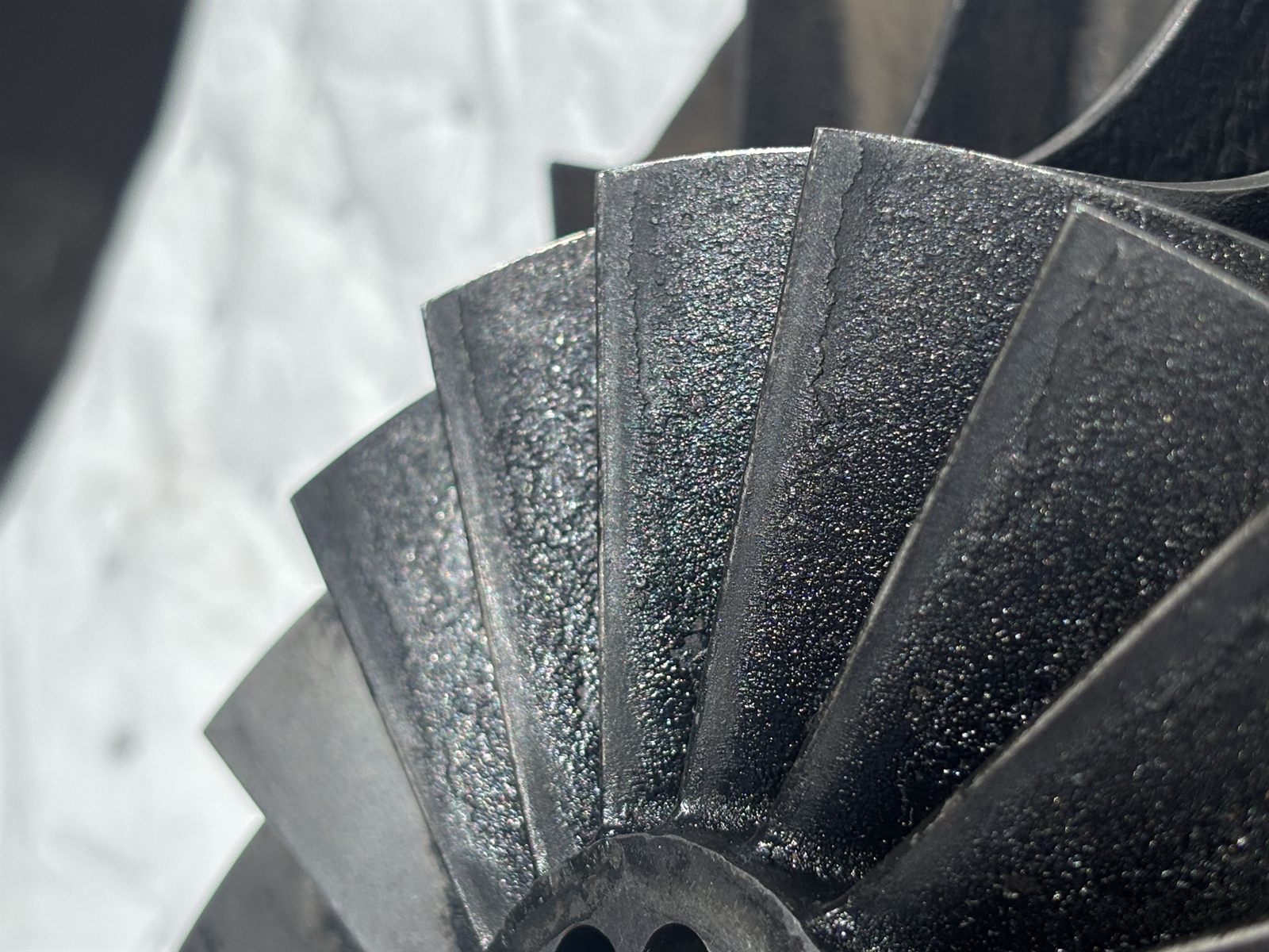 Baked carbon deposits packed into fin fan impeller blade roots before cleaning