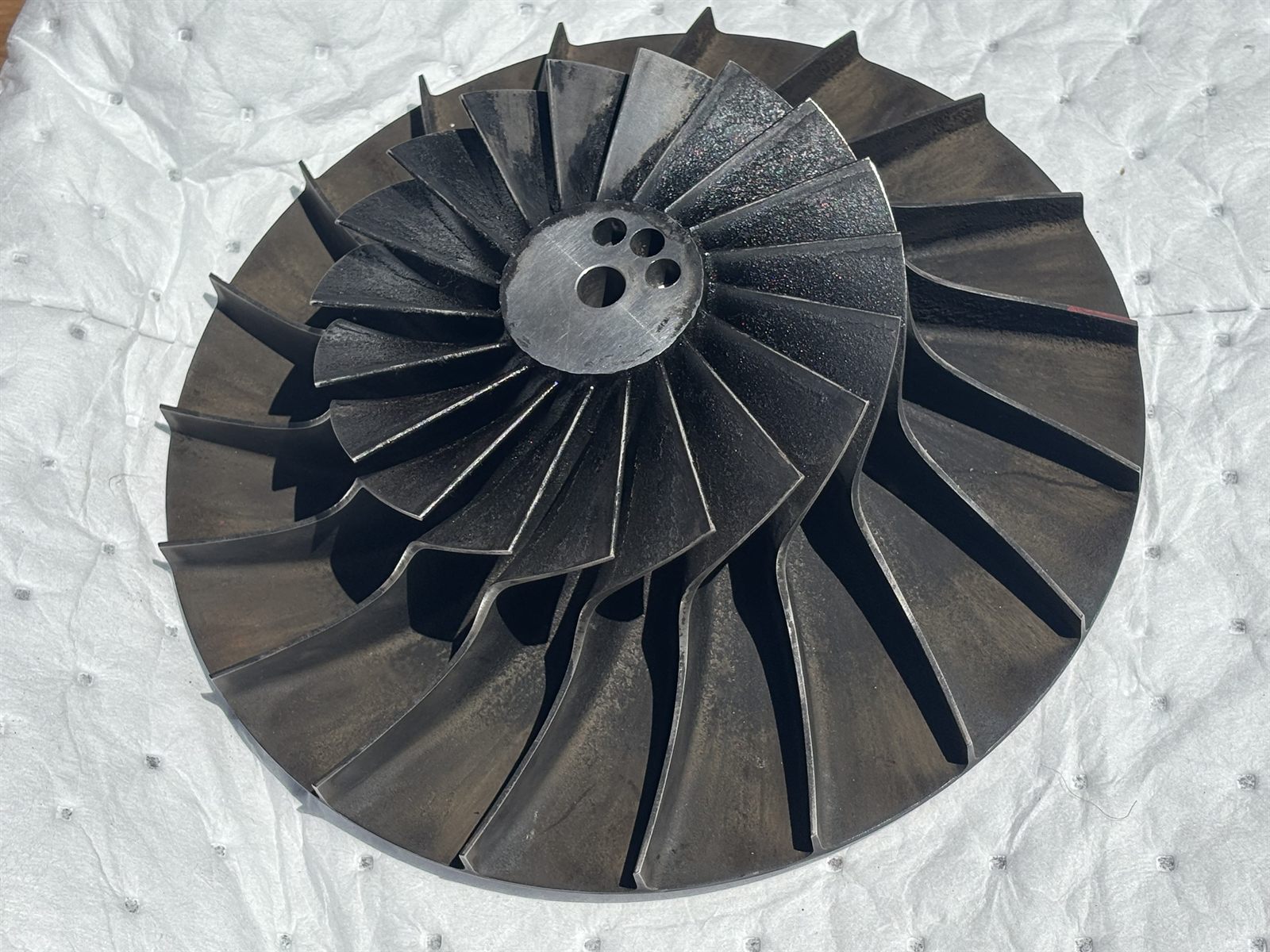 Fin fan impeller as received, blades and gas path darkened by oil varnish and carbon